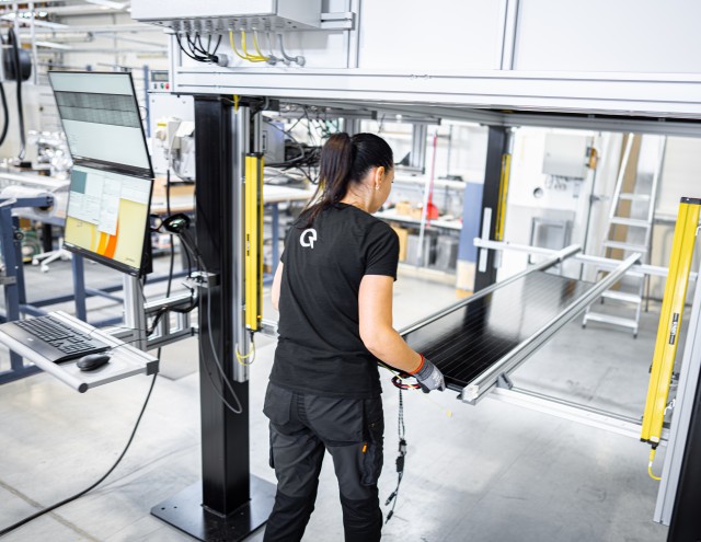 Solarstone factory worker using a new custom made testing station