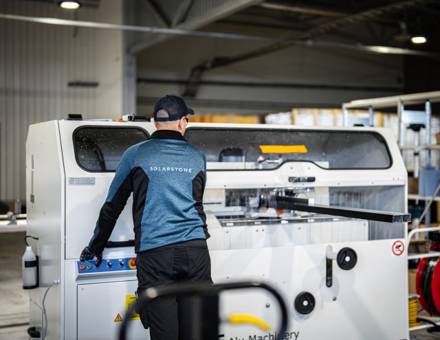 Solarstone factory employee working with new precision machinery