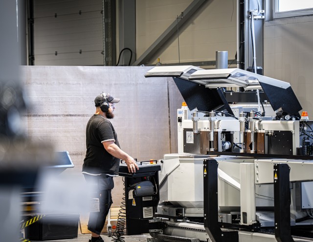 Solarstone employee using a new machine